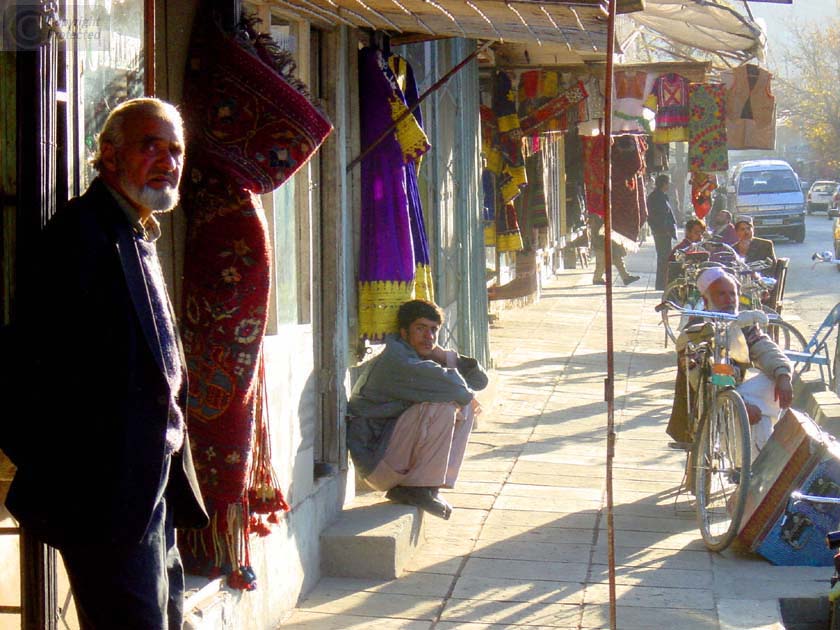 Two Men in front of Shops on Chicken Street